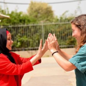 Two girls clapping hands